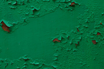 Old green painted wall with peeling paint. Abstract background for design.