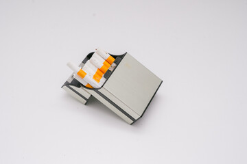 Several cigarettes and their packaging made of sturdy plastic show the elegance of a cigarette