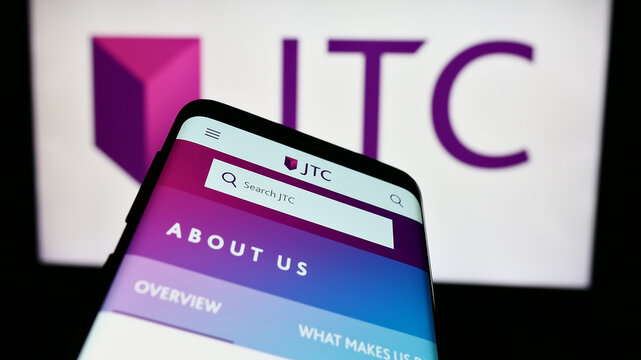 Stuttgart, Germany - 03-23-2024: Mobile phone with website of fund administration company JTC plc in front of business logo. Focus on top-left of phone display.