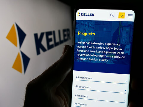Stuttgart, Germany - 03-23-2024: Person holding cellphone with webpage of geotechnical engineering company Keller Group plc in front of logo. Focus on center of phone display.