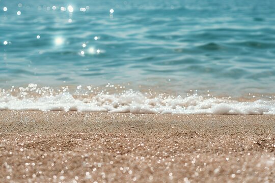 Light sand of beach against backdrop of sparkling ocean water