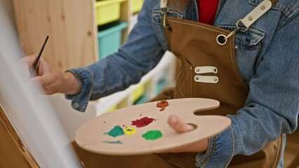 Captivating interior of art studio, man artist's hands drawing on canvas, creativity unleashed