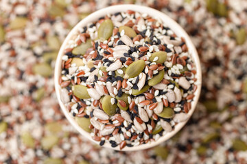 Mixed seeds sunflower, black and white sesame, flax and pumpkin in bowl. Top view