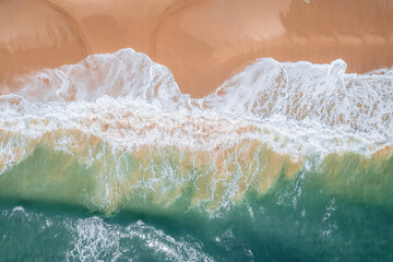 Fototapeta na wymiar Nature's Brushstrokes: Waves Against the Rocky Shore