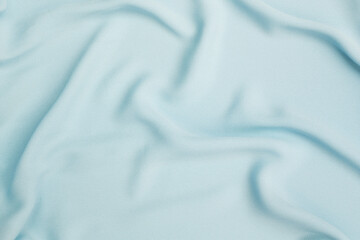 Naklejka premium Closeup waving blue fabric background, blank blue fabric texture background