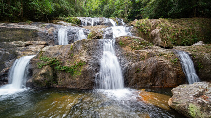 Fototapeta na wymiar waterfalls in deep forest at Srinakarin National Park ,A beautiful stream water famous rainforest waterfall in Thailand 