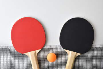Set of table tennis paddles net and ball on white