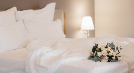 Fototapeta na wymiar Wedding Bouquet on a Messy Bed, Symbolizing Bridal Preparation