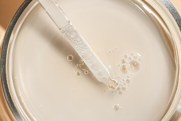 Cosmetic dropper pipette with drop transparent texture  on white background