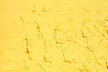 Liquid yellow lemon cosmetic gel or serum texture smudge background