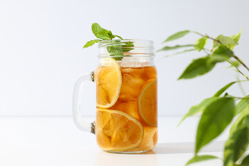 A glass of delicious cold tea on a white background