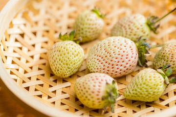 White strawberry arranged on a basket