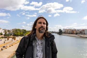 Close-up of a happy man on vacation on the Triana bridge in Seville