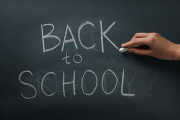 Chalk writing on the blackboard: "Back to school"