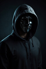 Fototapeta premium Portrait of dangerous hooded hacker in mask at dark background, horror look. Internet, cyber crime, cyber attack, system breaking and malware concept. Anonymous network concept. Copy ad text space