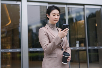 Corporate Professional Engaging with Tech on the Go - 777007595