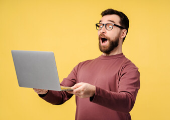 Excited amazed man using laptop, high speed internet, connection isolated