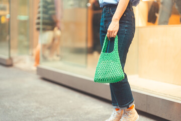 Woman hand hodling woven bag urban people lifestyles