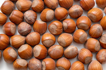 natural hazelnuts on white surface - close macro photo