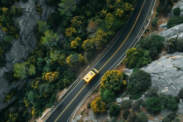 Fototapeta na wymiar Yellow car on winding road through rocky terrain