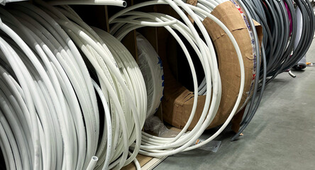 Stacks of grey insulation tubes for pipes in a store. International Repair Day. World Plumber Day
