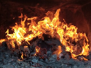 Burning firepaper and coals of a fire. Background for grilled food with fire.