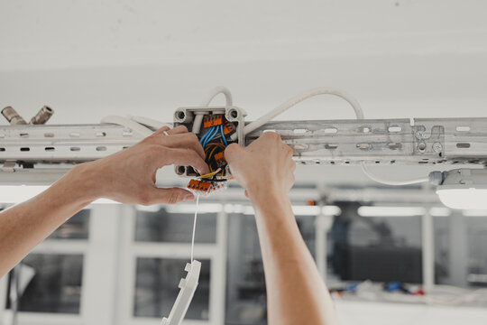 Electrical Junction Wiring, Electrical Installation, Hands of a Electrician Tightening Wires
