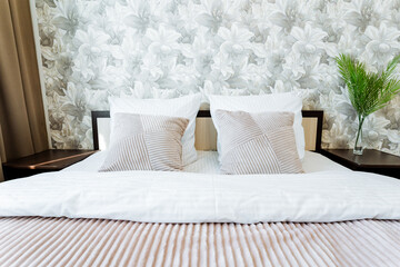 A hardwood bed with white sheets and pillows in a bedroom for ultimate comfort