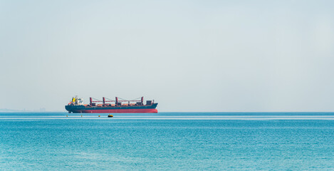 Bulk carrier ship waiting at the port entrance of the city