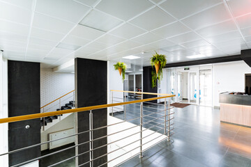 A building with a glass railing, stairs, and flooring