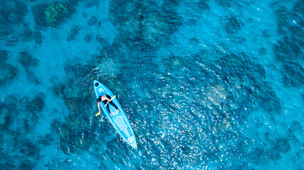 Aerial view of a kayak in the blue sea .Woman kayaking She does water sports activities	