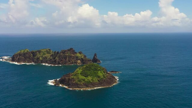 Top view of rocky tropical island in the blue ocean. Dos Hermanos Island. Santa Ana, Cagayan. Philippines.