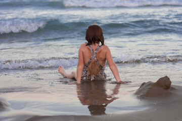 redhead girl looking calm and relaxed towards horizon alone on the coast. Feeling. emotion concept....