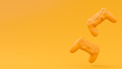 Video game joysticks or gamepads in plain monochrome yellow color background © Vasyl Onyskiv
