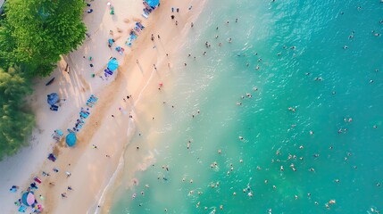 Top-down view capturing the lively atmosphere of a packed beach with people swimming in the sea and relaxing under colorful umbrellas on the sand..