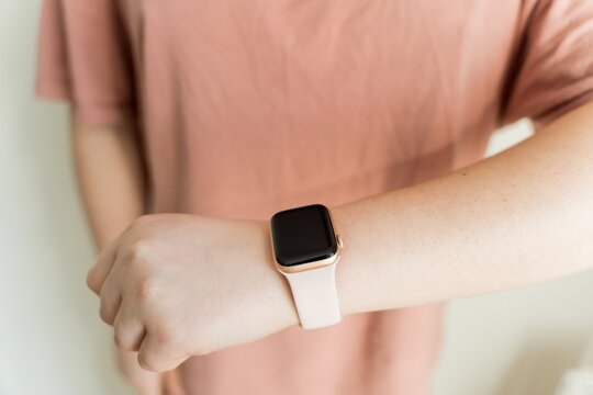 Kaliningrad, Russia - March 9, 2021: Smart clock on hand at a young woman. Close-up of Apple Watch SE series. 