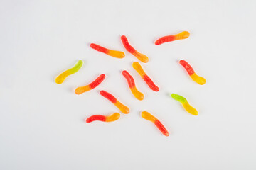 Fruit flavored worm shape, jelly candies. Isolated on white background.