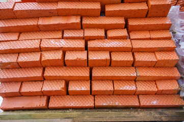 Close-up of orange bricks. Warehouse of building materials