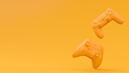 Video game joysticks or gamepads in plain monochrome yellow color background