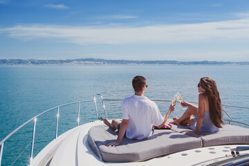 couple drinking champagne on luxury boat, luxurious yacht cruise in tropical sea - 777067743