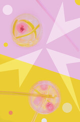 Abstraction, photo mixed with graphics: drinks on pink and yellow background with different geometric shapes. Flat lay.