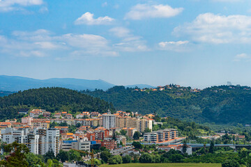 Fototapeta na wymiar A view of Coimbra City under a beautiful clear sky, with trees and buildings. Landscape background and wallpaper.