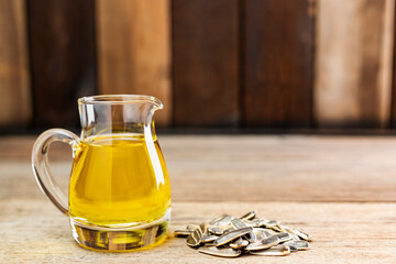 Sunflower oil and sunflower seeds On a traditional rustic wooden floor Concept of organic food and...