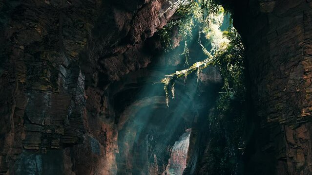 A mesmerizing green light shining through the entrance of a mystical cave