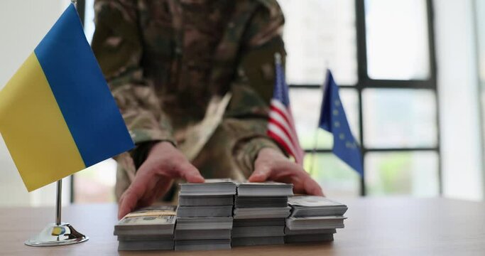 Military man handing over lot of money at negotiating table of ukraine with european union and usa closeup 4k movie slow motion. International financial assistance to Ukrainian people during war with
