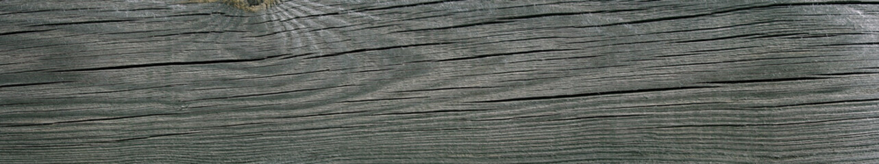 Texture of an old weathered cracked wooden board. Natural wide Background.