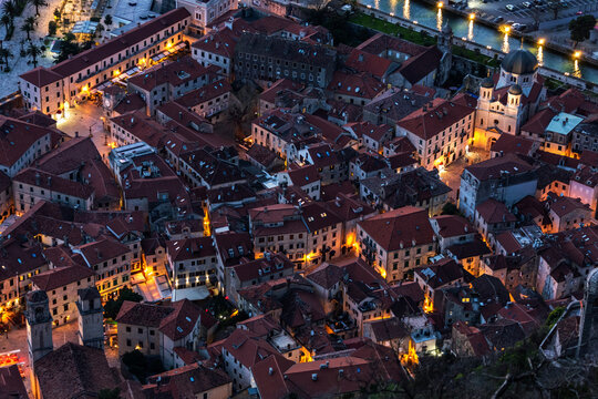Twilight over Kotor. Aerial view of historic town and lights reflecting on water,travel and cultural themes. Boka Kotorska, Montenegro