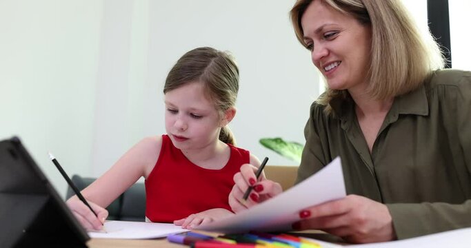 Little girl studying with teacher at lesson of fine arts in school 4k movie slow motion. Education for preschoolers concept
