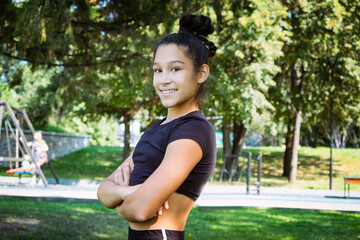 portrait of a teenage girl in a sports uniform on a summer day in the park