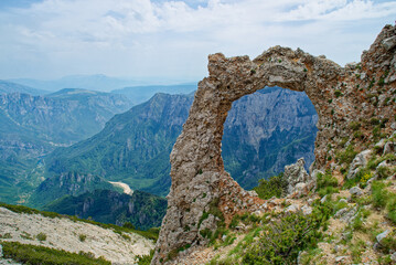 View of circular rock formation in the mountains. Natural monument Hajdučka vrata in Čvrsnica...